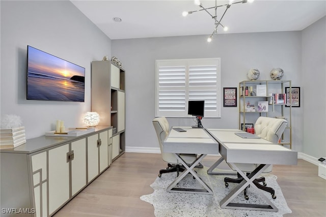 home office featuring light wood-type flooring and a chandelier