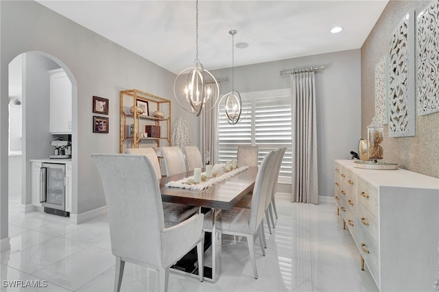 dining area featuring beverage cooler and a chandelier