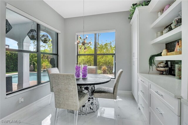14690 Reserve Pl, Naples, FL 34109 - dining area featuring healthy amount of natural light and baseboards