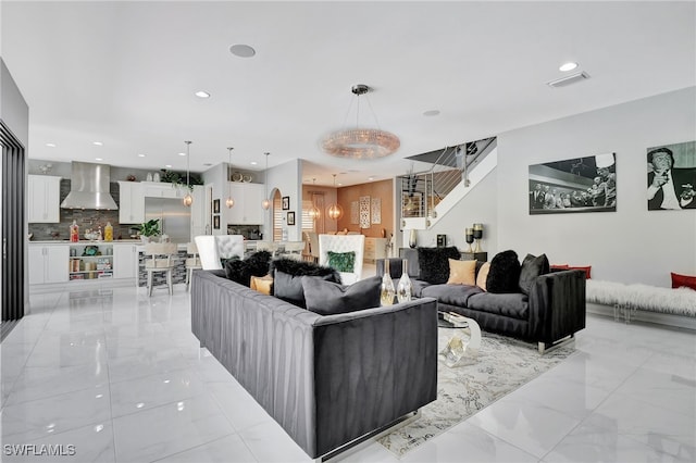 14690 Reserve Pl, Naples, FL 34109 - living area featuring light marble finish flooring, recessed lighting, and stairs