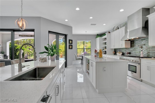 14690 Reserve Pl, Naples, FL 34109 - kitchen featuring high end range, a sink, wall chimney range hood, open shelves, and decorative backsplash