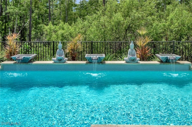 view of swimming pool featuring pool water feature