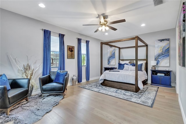 bedroom with ceiling fan and light wood-type flooring