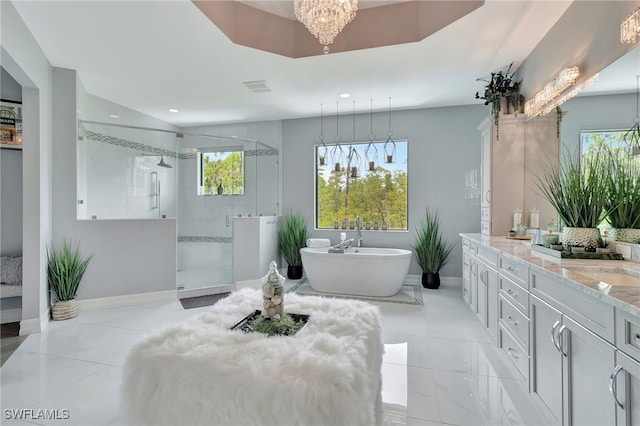 bathroom with vanity and independent shower and bath