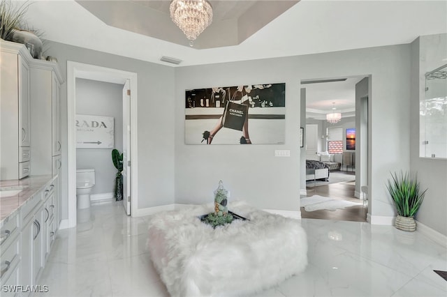 14690 Reserve Pl, Naples, FL 34109 - dining area with a chandelier, light marble finish flooring, and baseboards