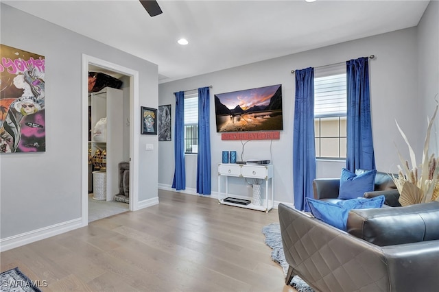 interior space with wood-type flooring and ceiling fan