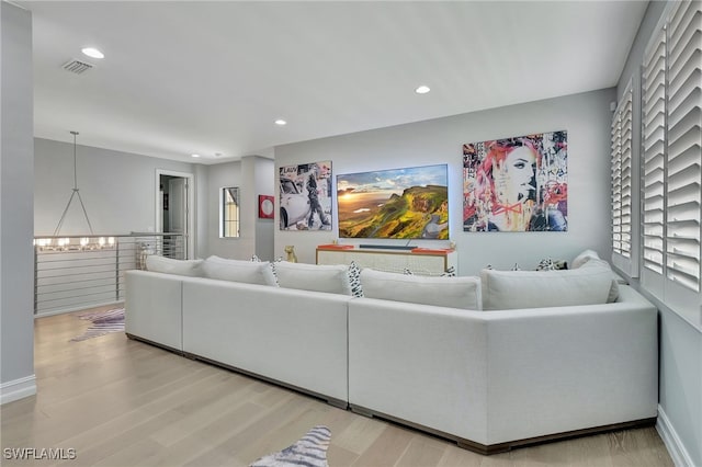 living room featuring hardwood / wood-style floors and a chandelier