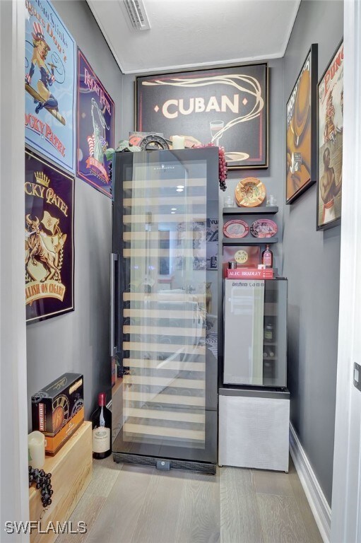 14690 Reserve Pl, Naples, FL 34109 - entryway with wine cooler and baseboards