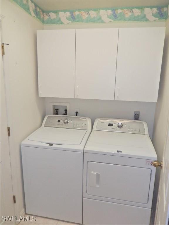 laundry room with cabinets and washing machine and dryer