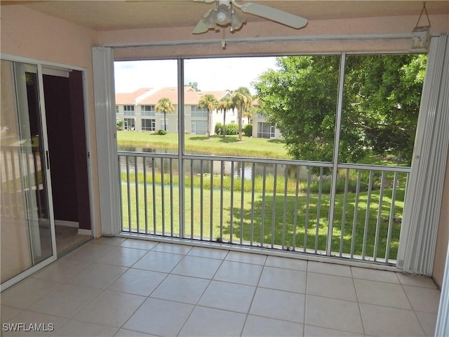 unfurnished sunroom with ceiling fan