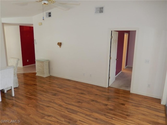 unfurnished room featuring lofted ceiling, ceiling fan, and dark hardwood / wood-style floors