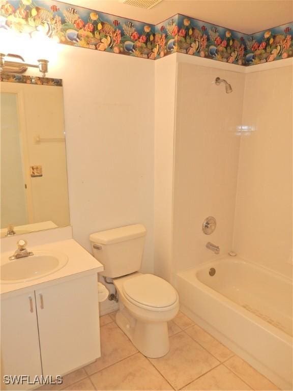 full bathroom with vanity, tub / shower combination, tile patterned floors, and toilet