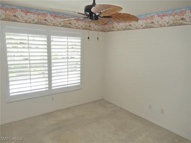 empty room with ceiling fan and carpet floors