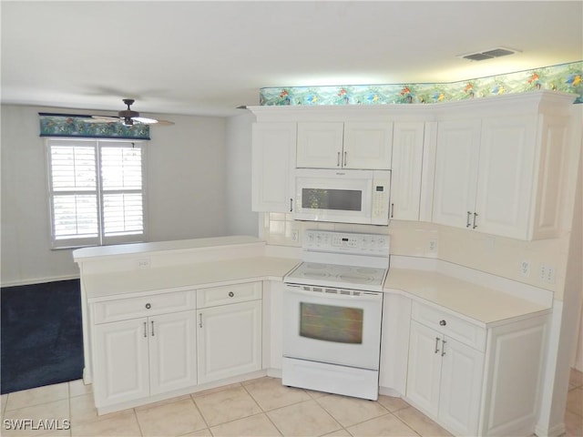 kitchen featuring white appliances, light tile patterned floors, kitchen peninsula, ceiling fan, and white cabinets