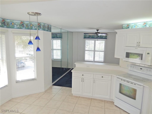 kitchen featuring white cabinetry, hanging light fixtures, light tile patterned floors, ceiling fan, and white appliances