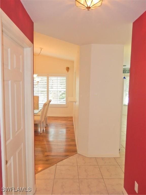 hall featuring light tile patterned flooring