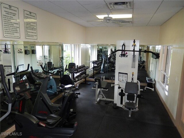 exercise room with a paneled ceiling and ceiling fan