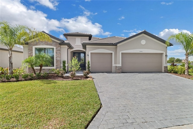 view of front of home featuring a garage and a front yard