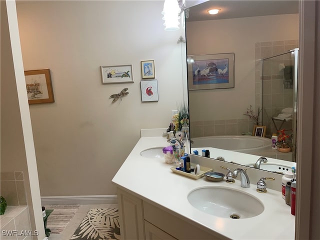 bathroom with vanity and independent shower and bath