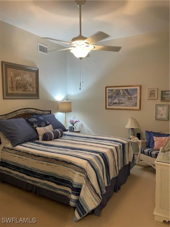 carpeted bedroom with visible vents and a ceiling fan