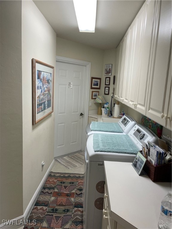 laundry area with cabinets and washer and clothes dryer