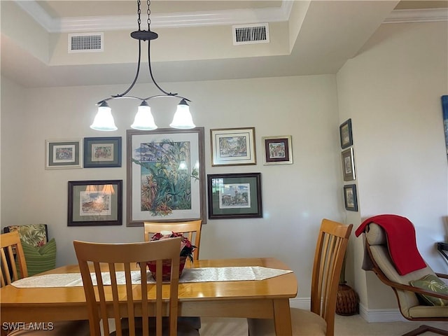 dining space with ornamental molding, visible vents, and baseboards