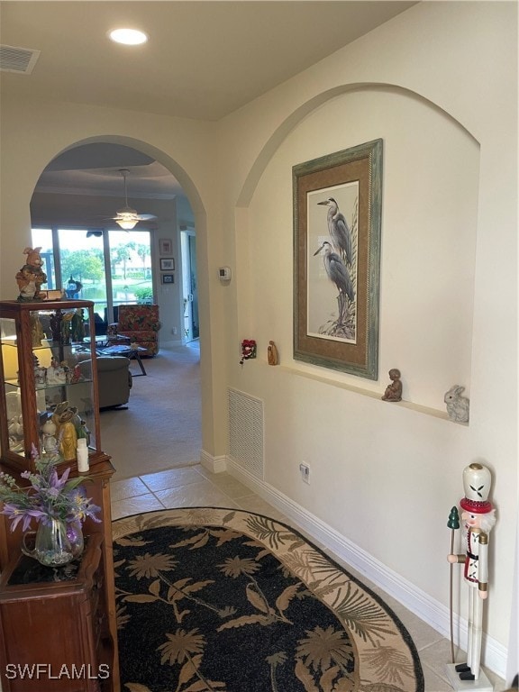 hall featuring light tile patterned flooring