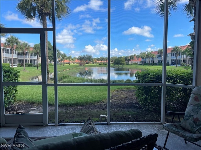 unfurnished sunroom with plenty of natural light and a water view