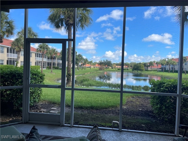 unfurnished sunroom with a water view