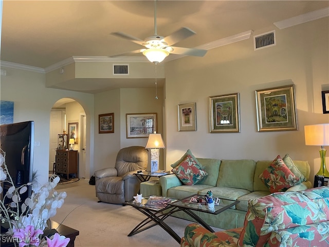 living room featuring ornamental molding, ceiling fan, and carpet floors