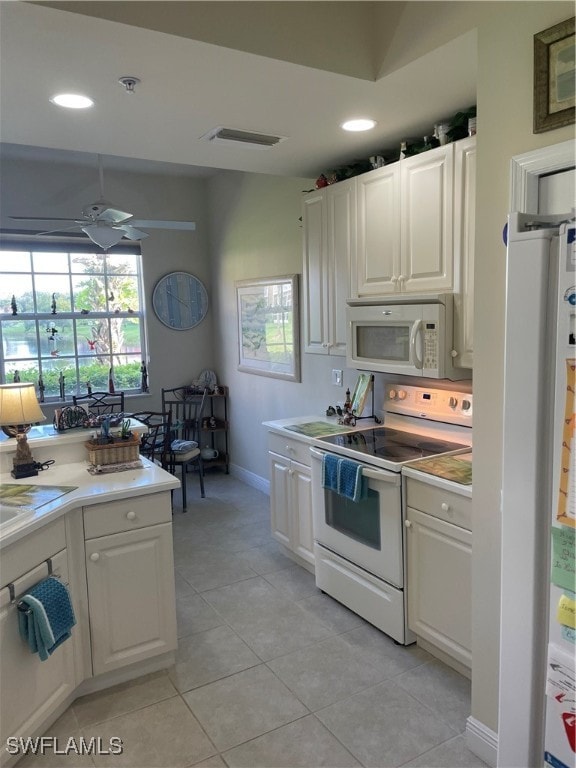 kitchen with white appliances, light tile patterned floors, white cabinetry, and ceiling fan