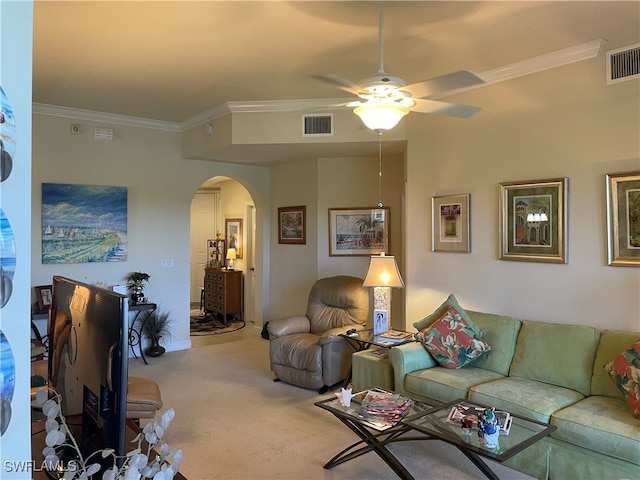 living room with ceiling fan, ornamental molding, and carpet floors