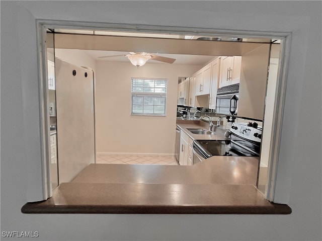 kitchen with ceiling fan, white cabinets, sink, and stainless steel electric range