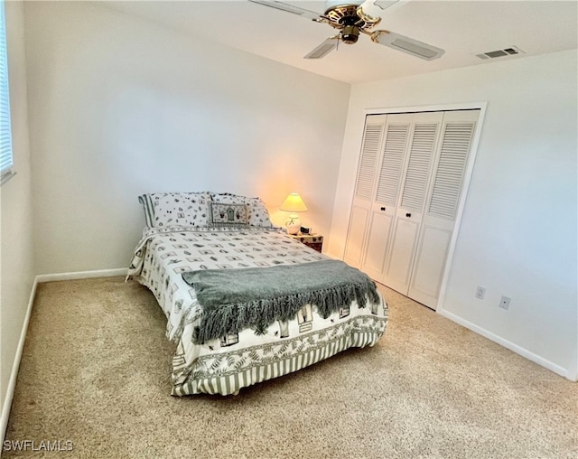 bedroom with carpet, ceiling fan, and a closet