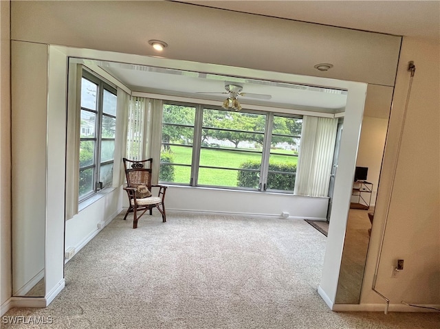 sunroom / solarium featuring ceiling fan and a wealth of natural light