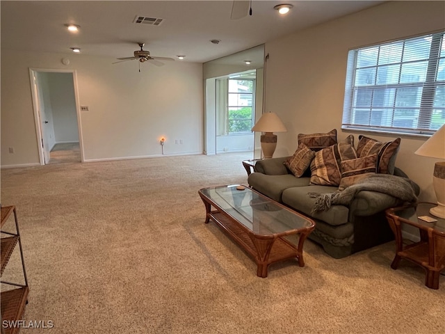 carpeted living room featuring ceiling fan