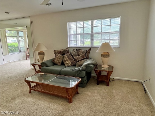 carpeted living room featuring ceiling fan