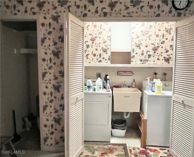 laundry room featuring washer and dryer, light tile patterned floors, and sink