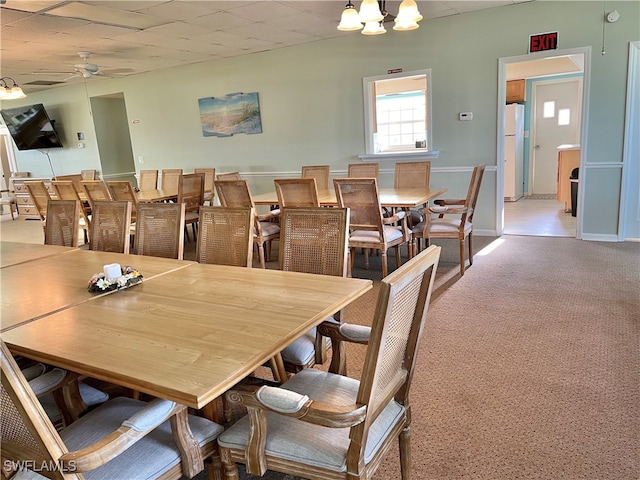 dining space with ceiling fan and carpet floors