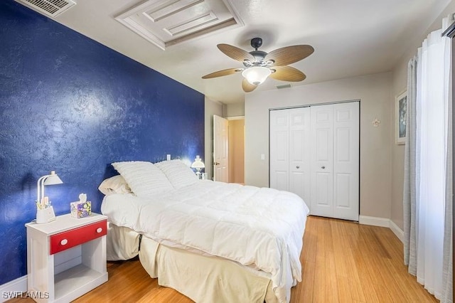 bedroom featuring ceiling fan, a closet, and light wood-type flooring