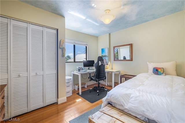 bedroom with a closet and light hardwood / wood-style floors