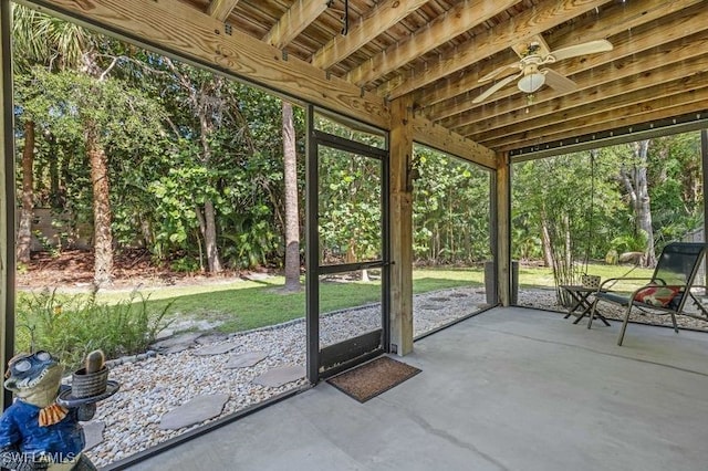 unfurnished sunroom featuring ceiling fan