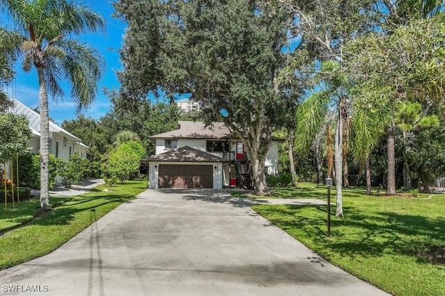 view of front of home featuring a front yard and a garage