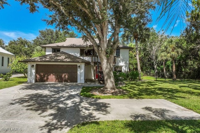 view of front of house with a front yard and a garage