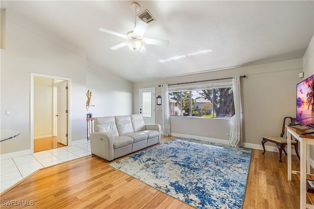 living room with ceiling fan and light hardwood / wood-style floors