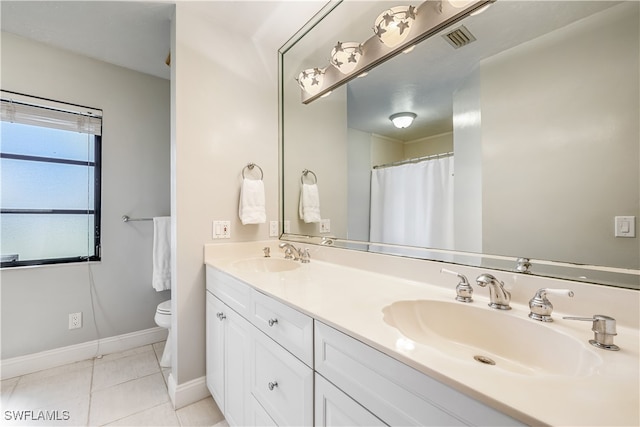 bathroom featuring vanity, toilet, walk in shower, and tile patterned flooring