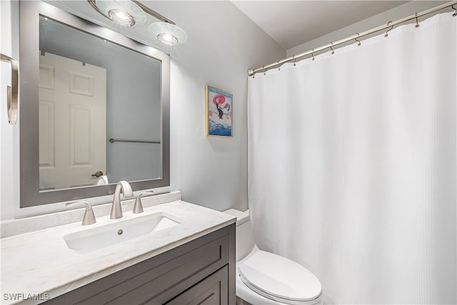 bathroom featuring toilet and vanity