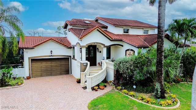 mediterranean / spanish-style home with a garage