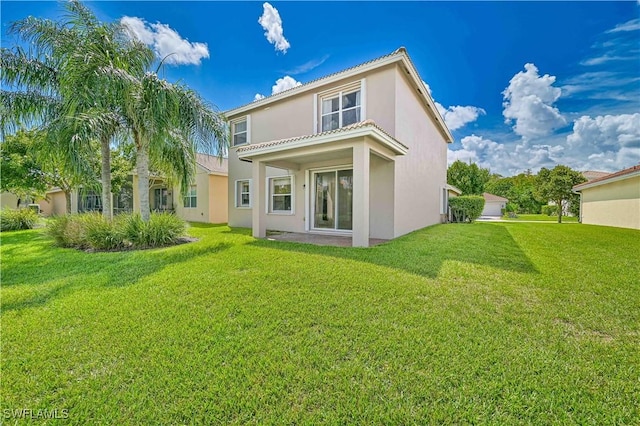 rear view of property featuring a yard