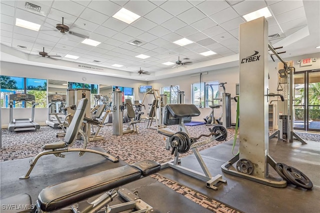 workout area with a drop ceiling and ceiling fan